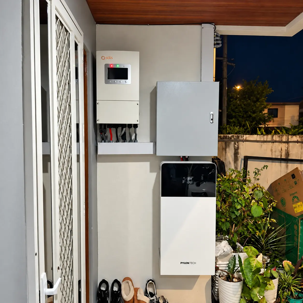 Hybrid inverter, electrical enclosure and battery installed beside a residential entryway in Cabuyao, Laguna