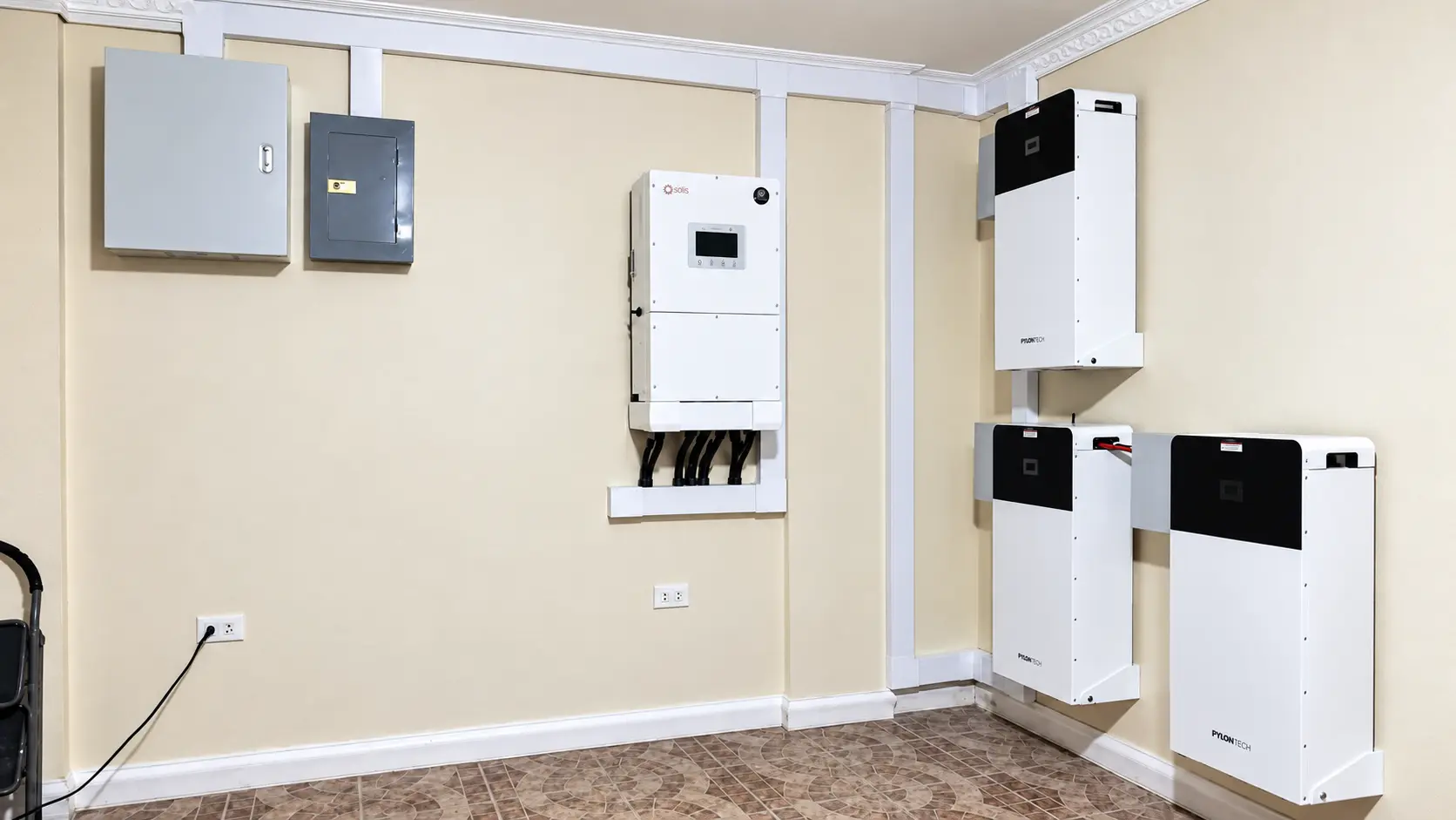 Hybrid inverter and multiple white battery cabinets installed in a room in Sto. Tomas, Batangas